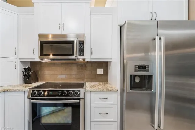 a stove top oven sitting inside of a kitchen