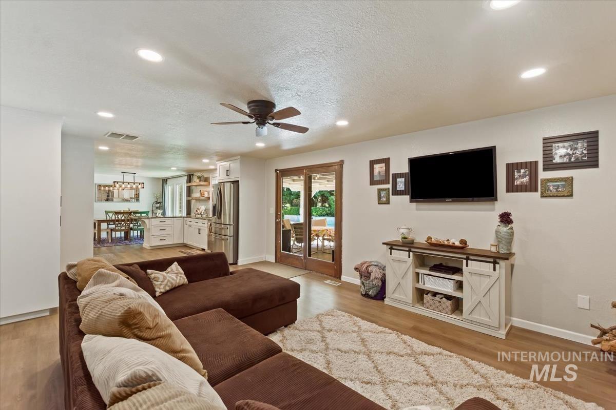 13712 Jarett Street Caldwell, ID 83607 - Photo 21 of 39 Living room with ceiling fan, recessed lighting, a textured ceiling, and light wood finished floors