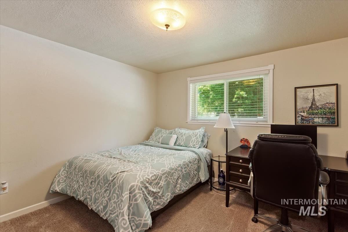 13712 Jarett Street Caldwell, ID 83607 - Photo 29 of 39 Carpeted bedroom with a textured ceiling and a desk