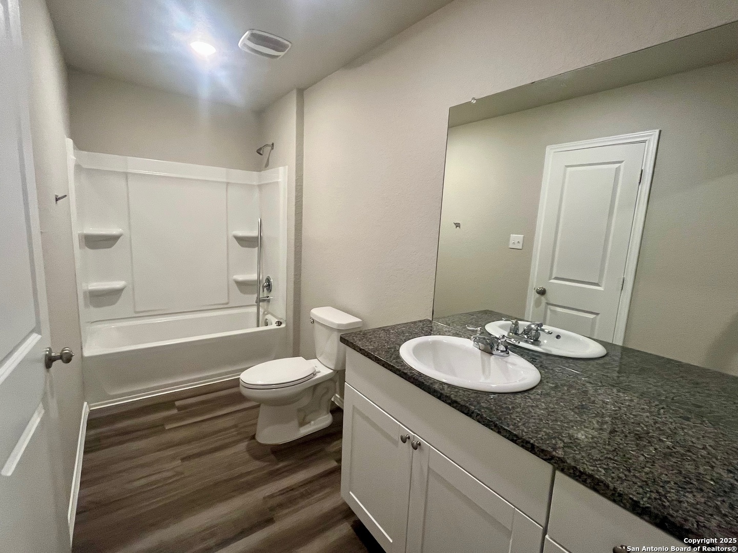 10418 Midsummer Meadow Converse, TX 78109 - Photo 13 of 24 a bathroom with a granite countertop sink toilet a mirror and shower