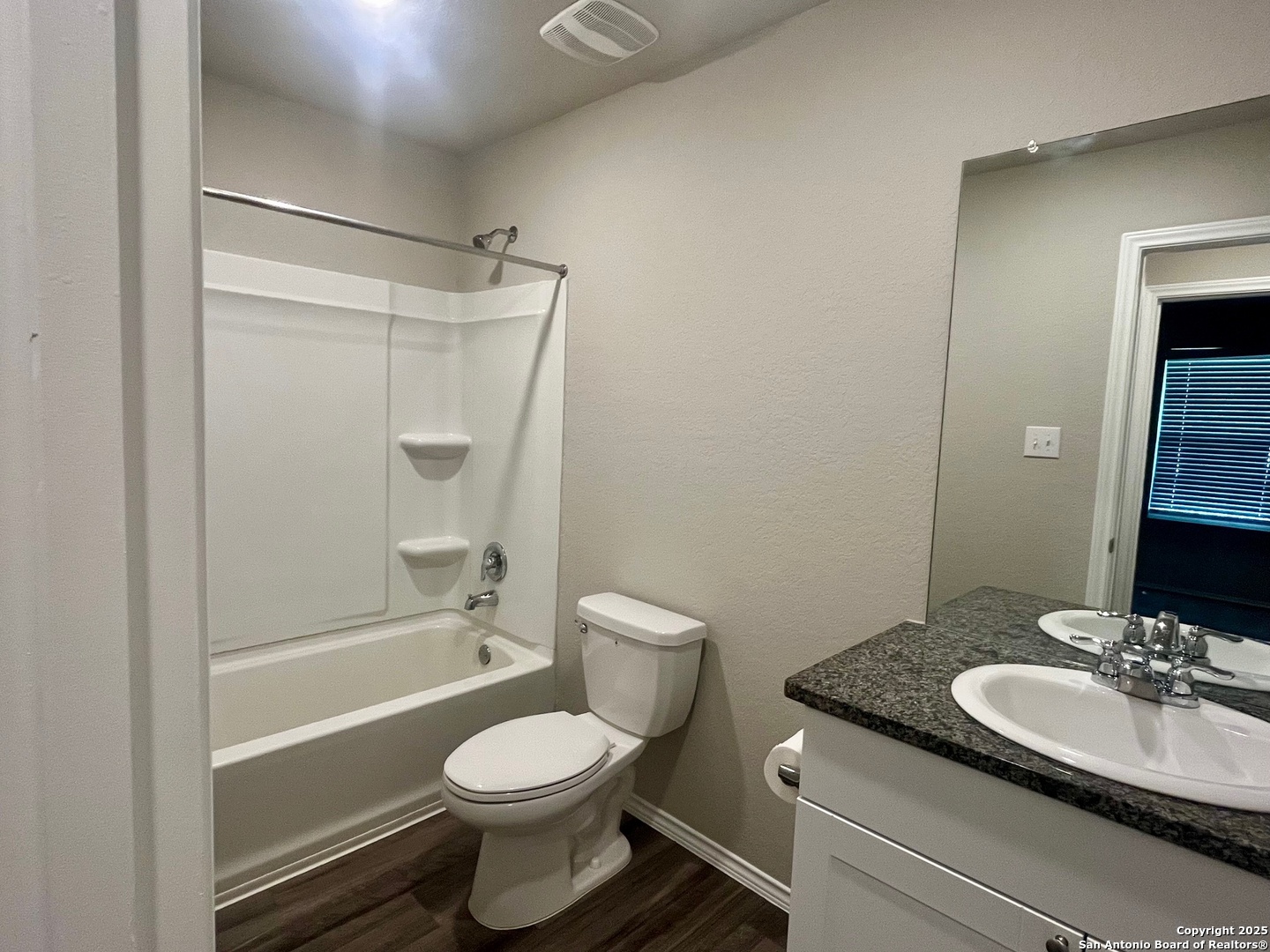 10418 Midsummer Meadow Converse, TX 78109 - Photo 16 of 24 a bathroom with a granite countertop sink toilet and shower