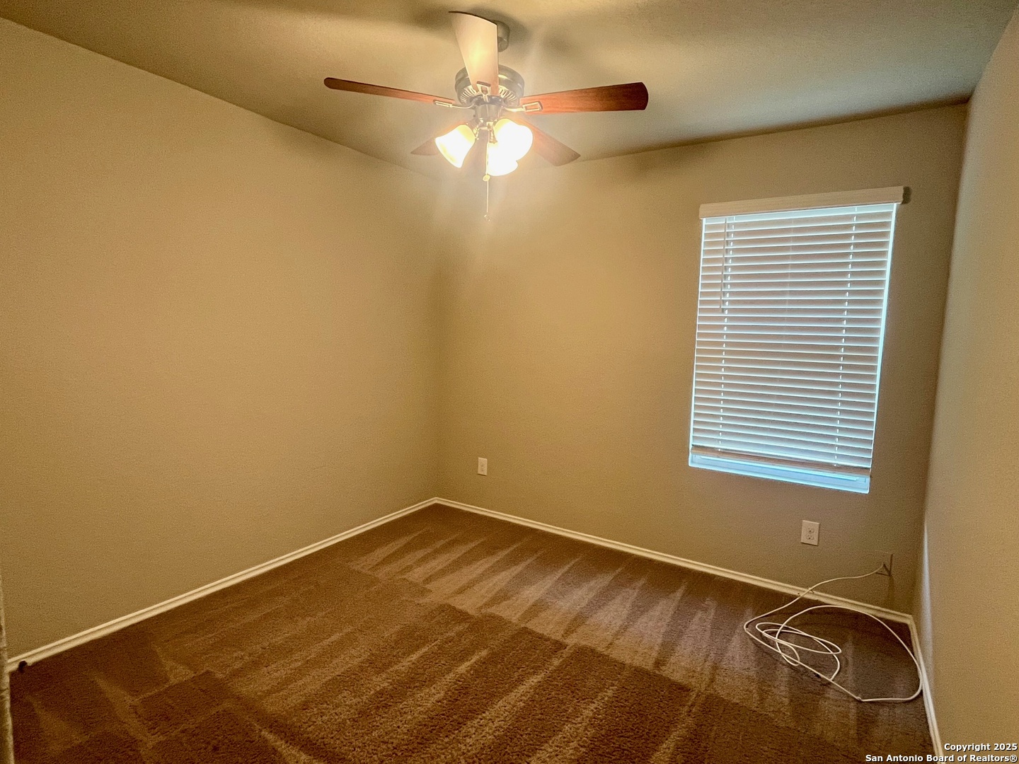 10418 Midsummer Meadow Converse, TX 78109 - Photo 17 of 24 a view of a room with a window and ceiling fan