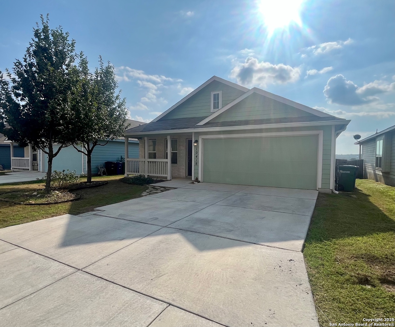 10418 Midsummer Meadow Converse, TX 78109 - Photo 2 of 24 a front view of a house with a yard and a garage