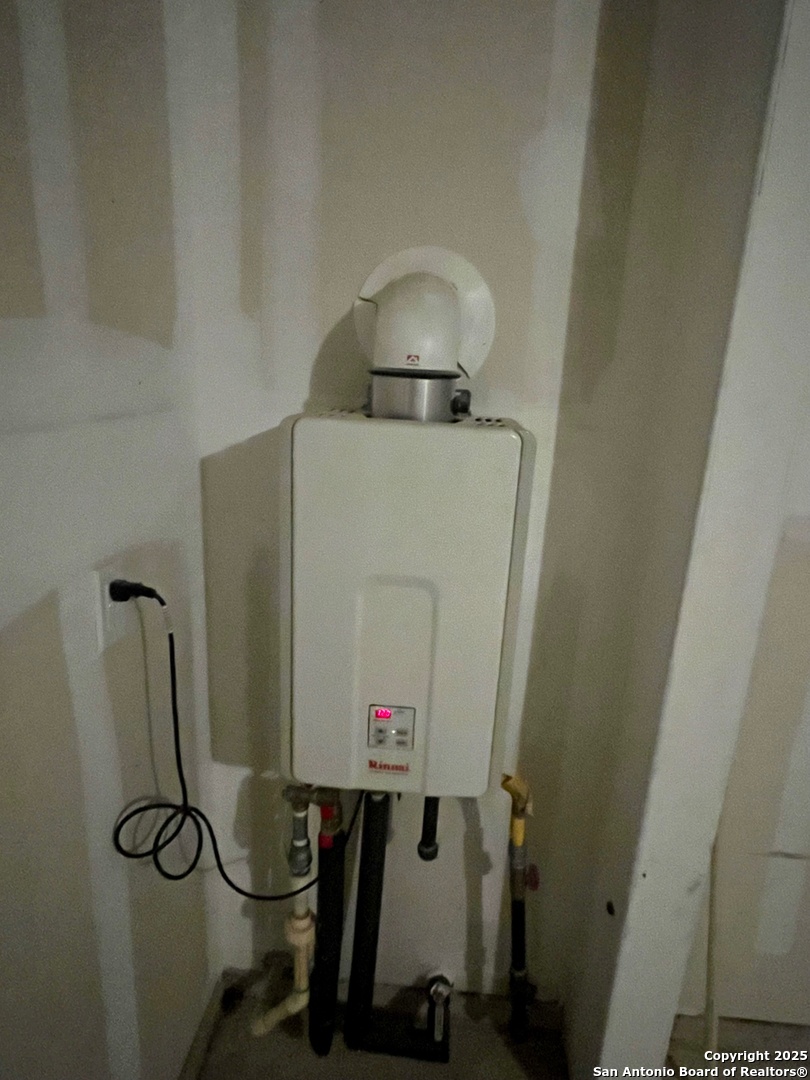 10418 Midsummer Meadow Converse, TX 78109 - Photo 21 of 24 a room with water heater and cabinets