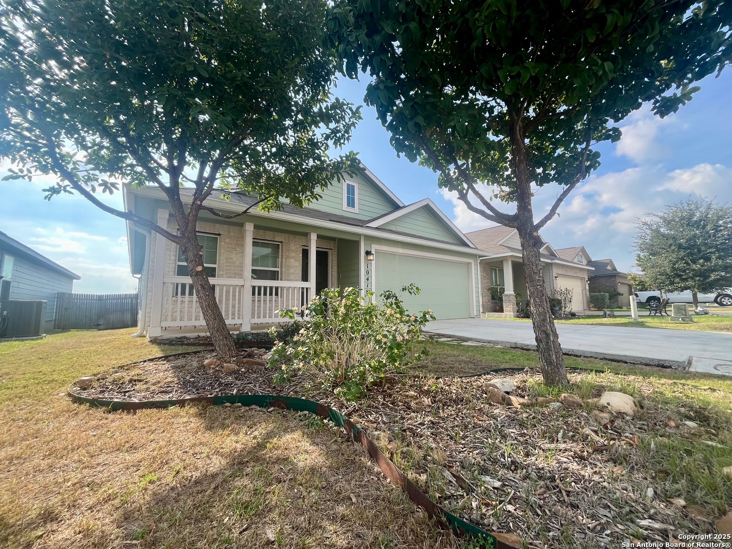 10418 Midsummer Meadow Converse, TX 78109 - Photo 3 of 24 a front view of a house with garden