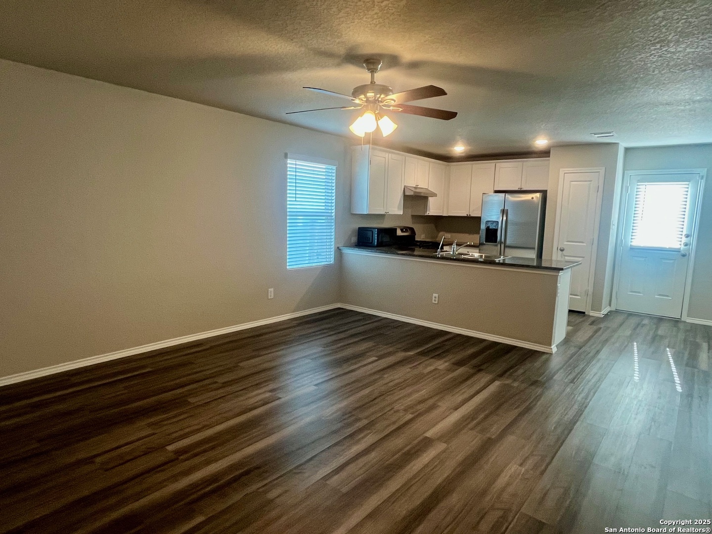 10418 Midsummer Meadow Converse, TX 78109 - Photo 7 of 24 a view of a kitchen with a sink wooden floor and a ceiling fan
