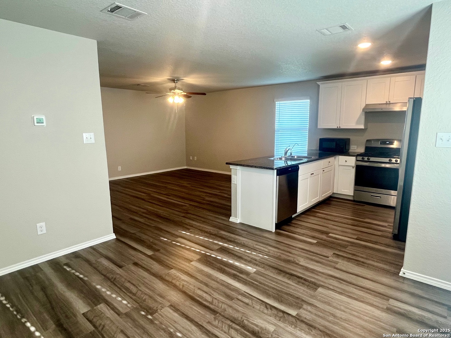 10418 Midsummer Meadow Converse, TX 78109 - Photo 8 of 24 a kitchen with stainless steel appliances a refrigerator and a stove top oven
