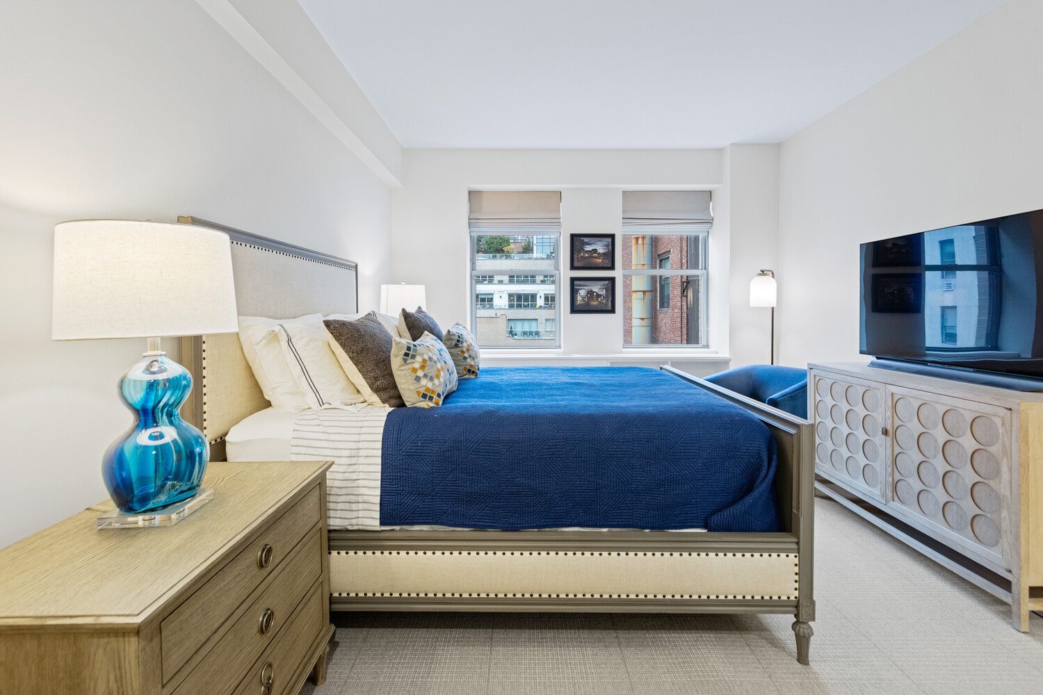 27 West 19th Street, Unit 12 Manhattan, NY 10011 - Photo 10 of 18 a bedroom with a bed and a couch