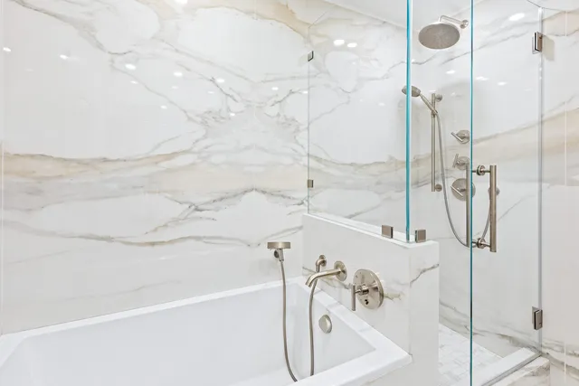 a bathroom with a bathtub and shower