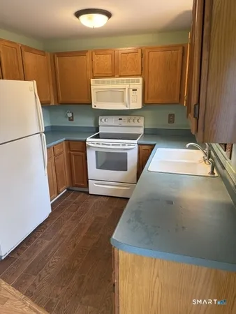 a kitchen with a refrigerator sink and cabinets