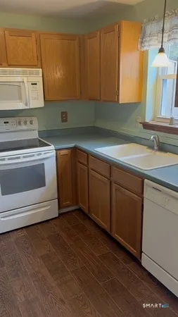 a kitchen with granite countertop a sink and a stove