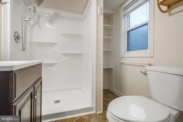 a white toilet sitting next to a bathroom sink