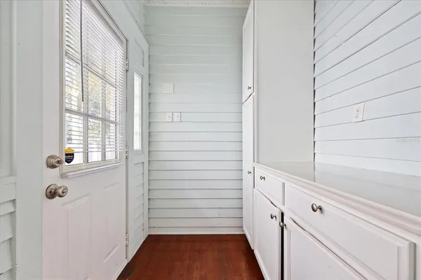 a workspace with wooden floor and a window