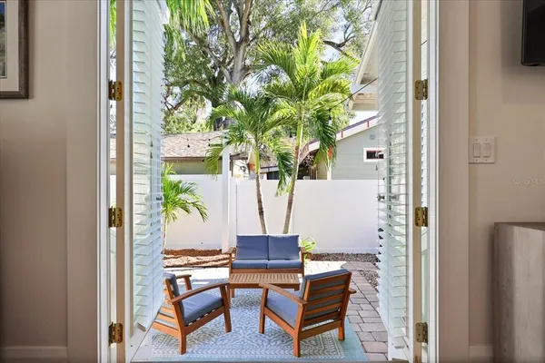 a backyard of a house with table and chairs
