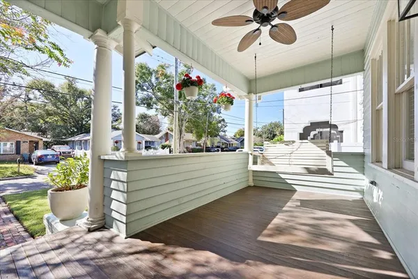 a view of a balcony with a dining table and chairs