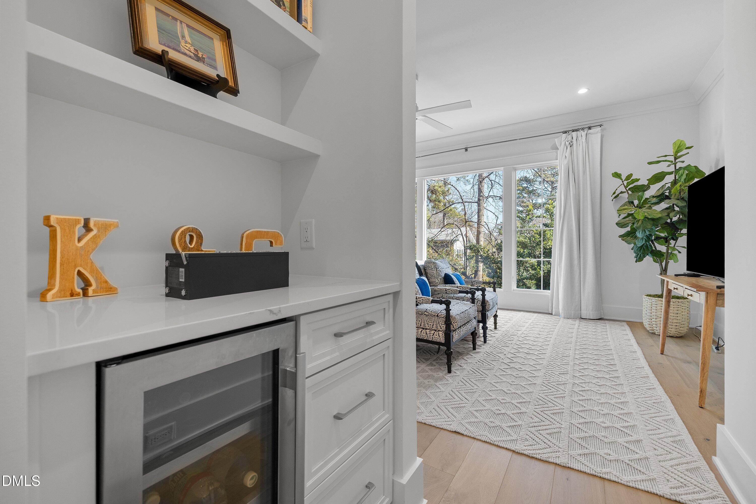 906 Brooks Avenue Raleigh, NC 27607 - Photo 29 of 64 a kitchen with a table chairs refrigerator and a window