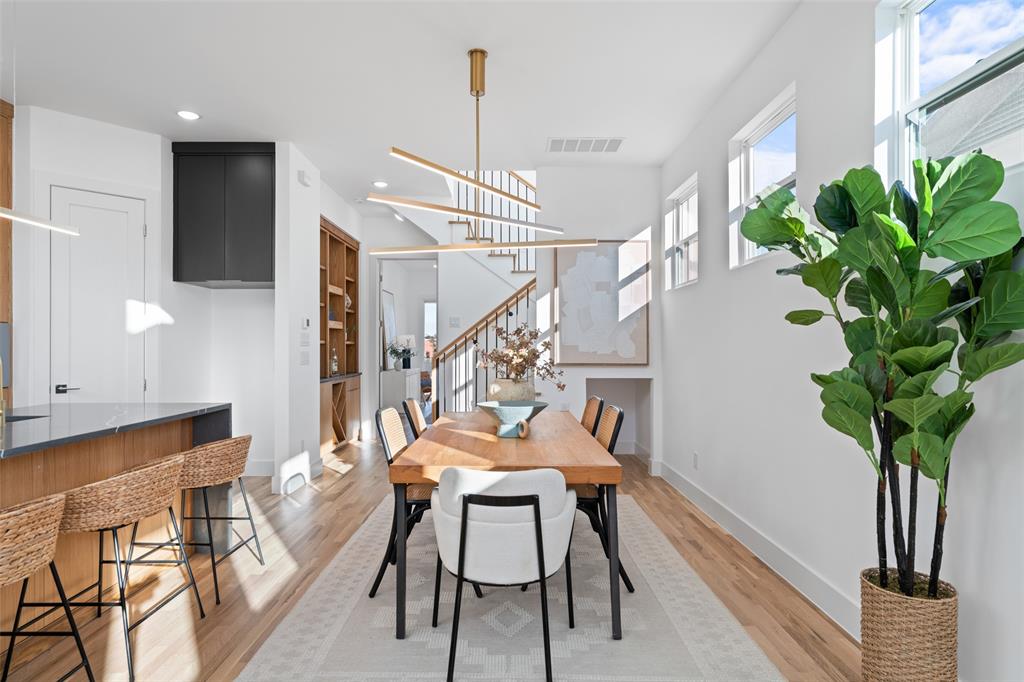 2313 South Vernon Avenue Dallas, TX 75224 - Photo 15 of 40 a dining room with furniture potted plants and wooden floor