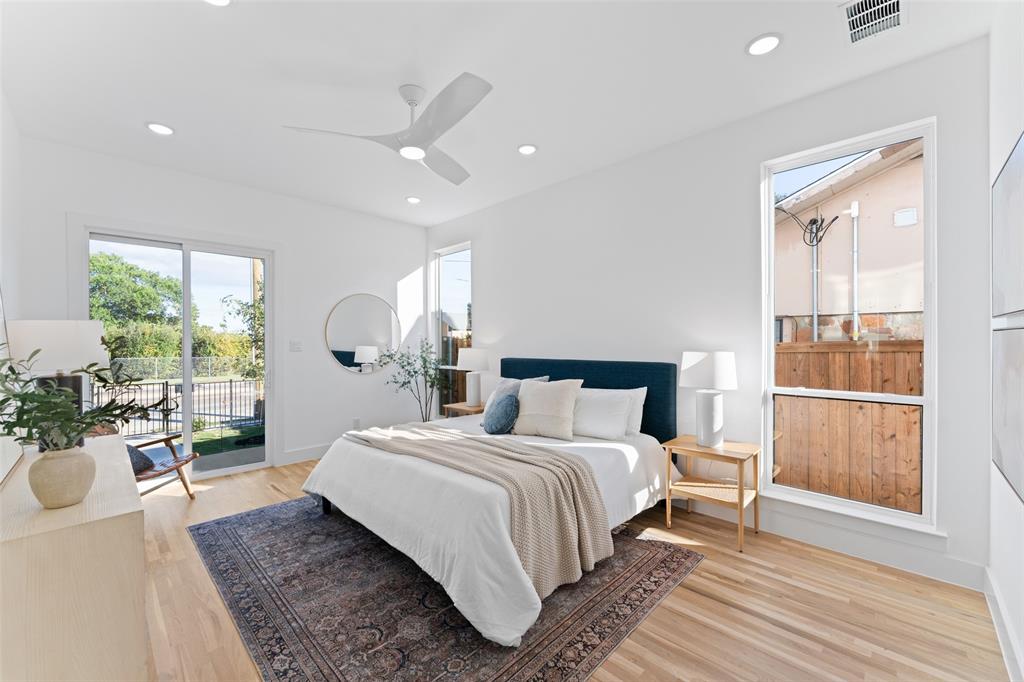 2313 South Vernon Avenue Dallas, TX 75224 - Photo 19 of 40 a bedroom with a large bed and wooden floor