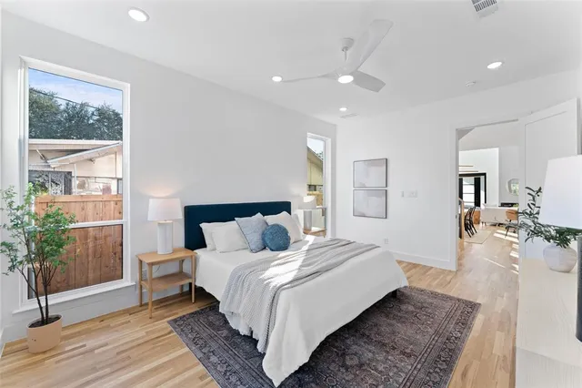 a bed room with a bed and a large window