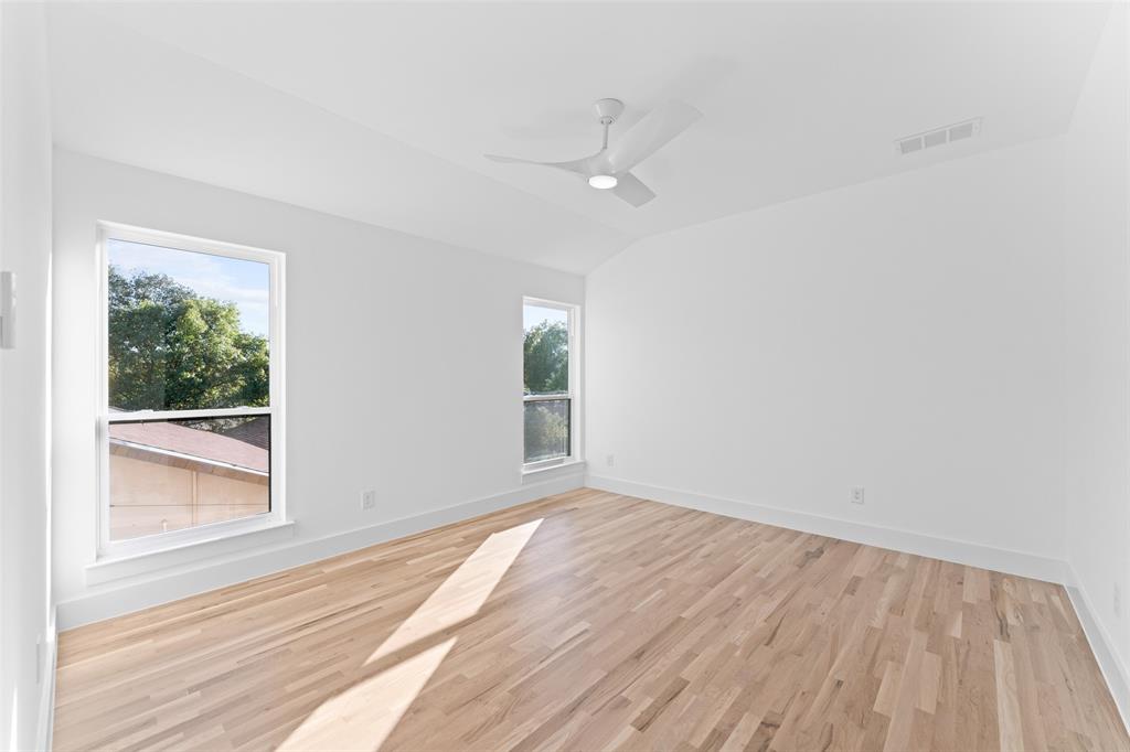 2313 South Vernon Avenue Dallas, TX 75224 - Photo 28 of 40 an empty room with wooden floor fan and windows