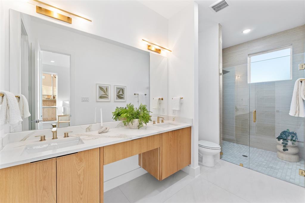 2313 South Vernon Avenue Dallas, TX 75224 - Photo 29 of 40 a bathroom with a sink double vanity granite tub shower and a mirror