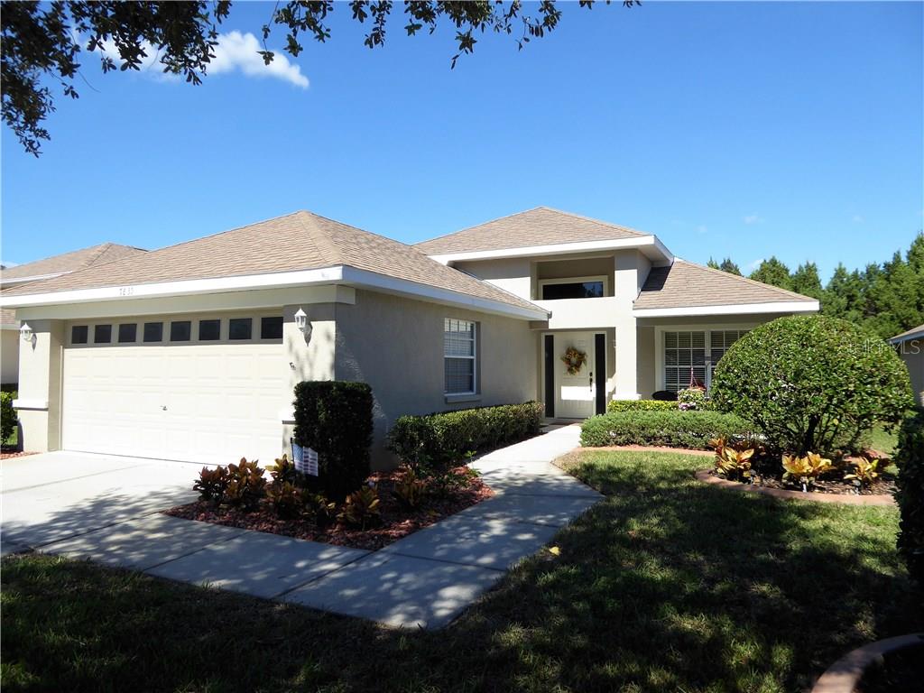 7835 Craighurst Loop New Port Richey, FL 34655 - Photo 1 of 1 a front view of a house with a garden
