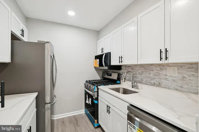 a kitchen with a refrigerator and a sink