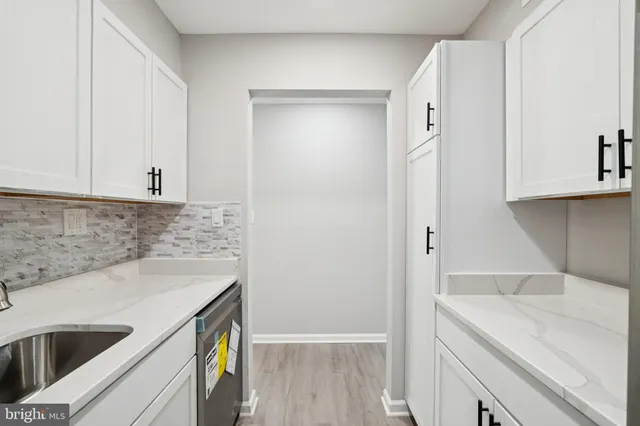 a kitchen with a sink and cabinets