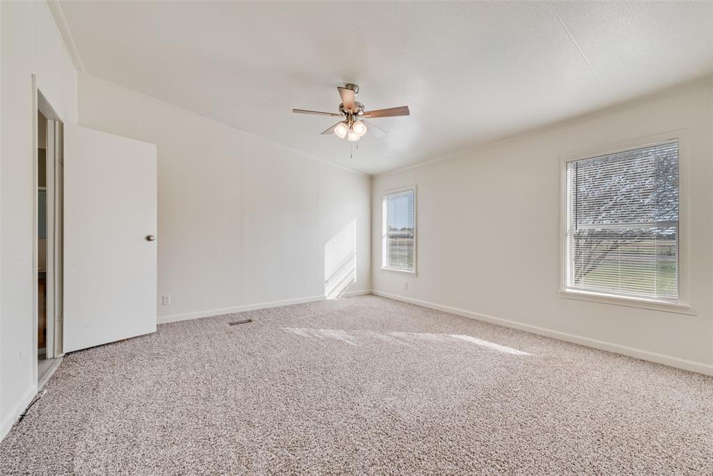 817 Kaufman Street Rosser, TX 75158 - Photo 19 of 29 Carpeted empty room featuring baseboards and a ceiling fan