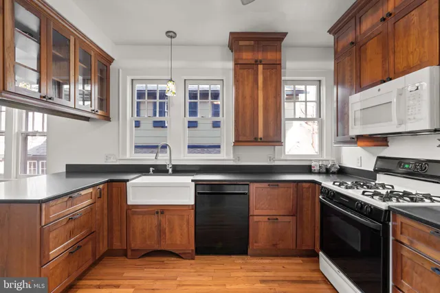 a kitchen with stainless steel appliances granite countertop a sink stove and cabinets