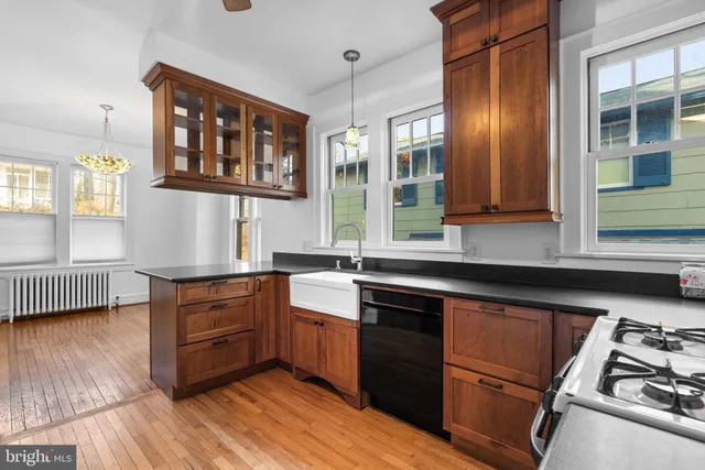 a kitchen with stainless steel appliances granite countertop a stove and a sink
