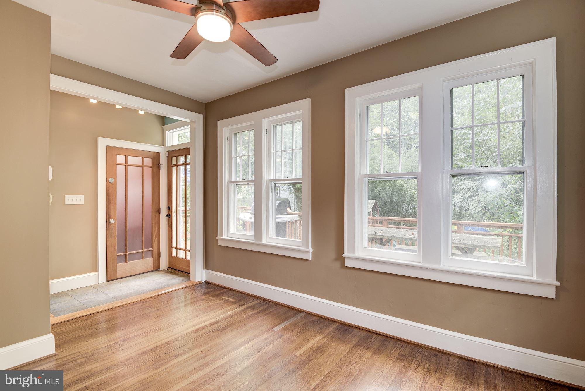 7413 Maple Avenue Takoma Park, MD 20912 - Photo 13 of 30 a view of an empty room with wooden floor and a window