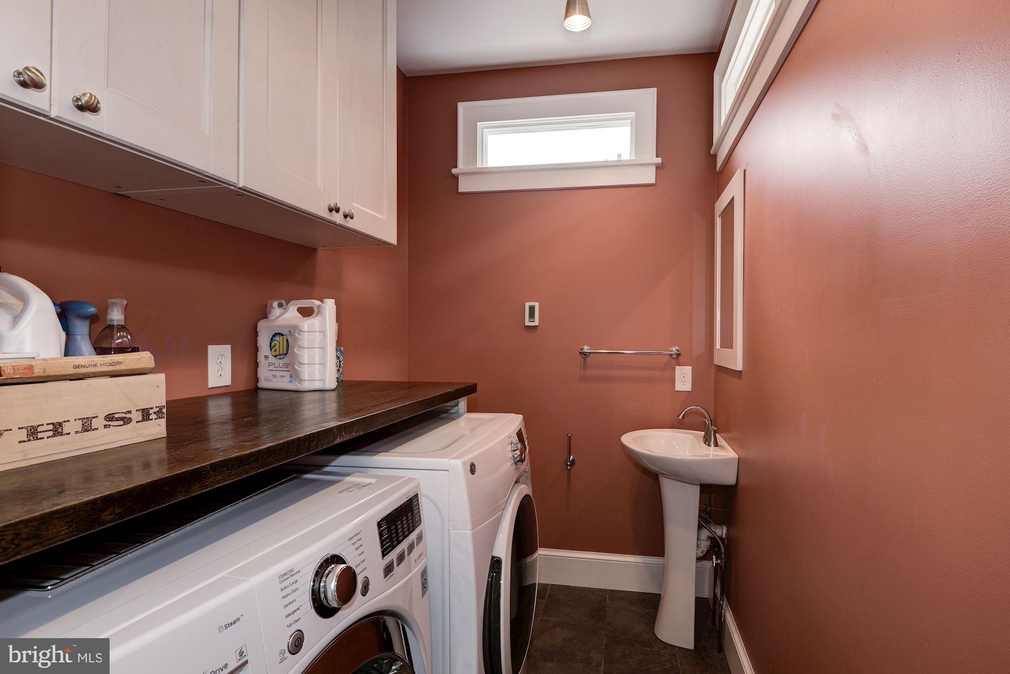 7413 Maple Avenue Takoma Park, MD 20912 - Photo 14 of 30 a bathroom with a sink a toilet and mirror