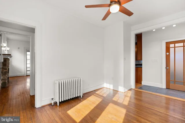 wooden floor in an empty room with a window