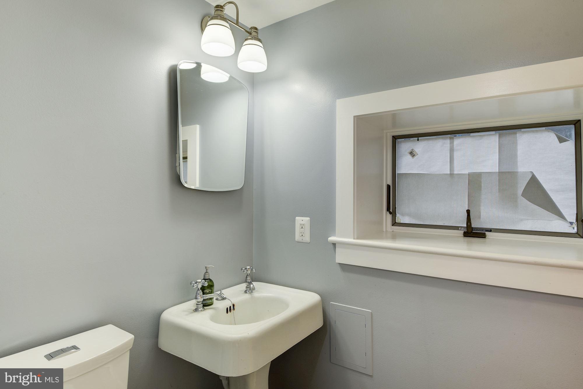 7413 Maple Avenue Takoma Park, MD 20912 - Photo 22 of 30 a bathroom with a sink and a mirror
