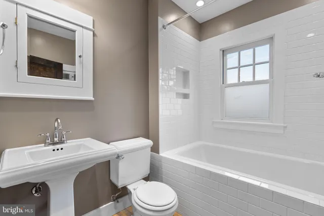 a bathroom with a toilet sink and bathtub