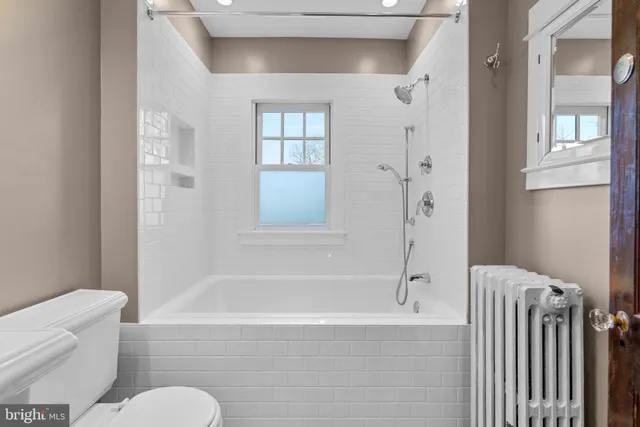 a bathroom with a toilet bathtub and shower