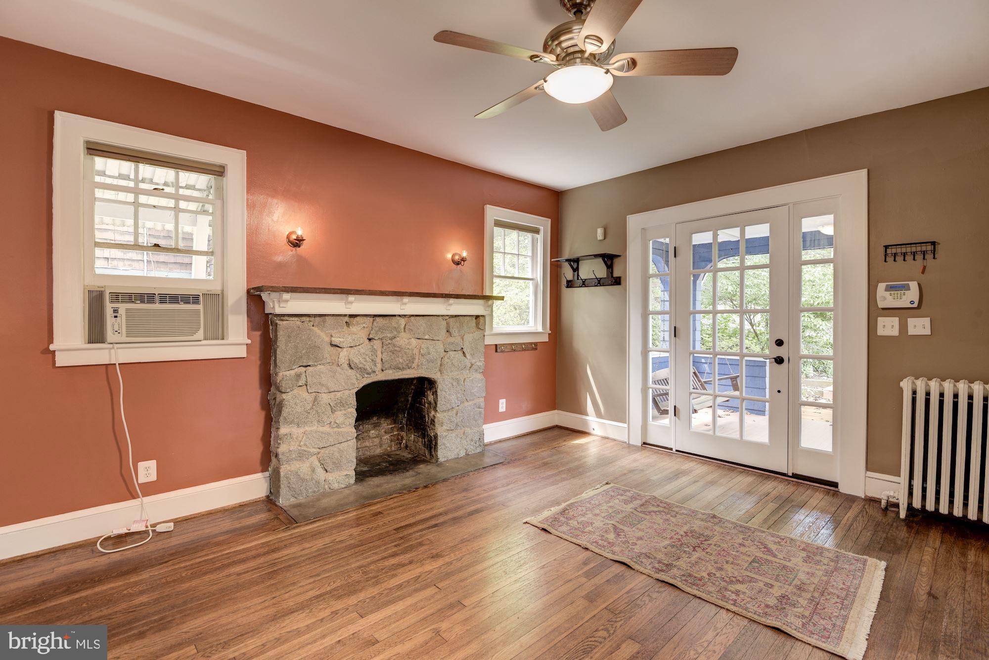 7413 Maple Avenue Takoma Park, MD 20912 - Photo 3 of 30 a view of an empty room with wooden floor and a window