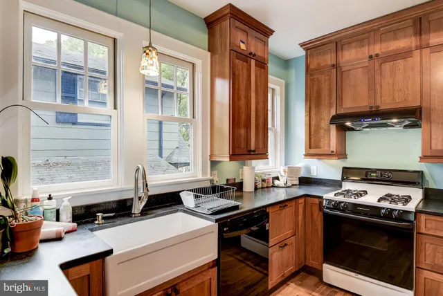 a kitchen with stainless steel appliances a stove sink and cabinets