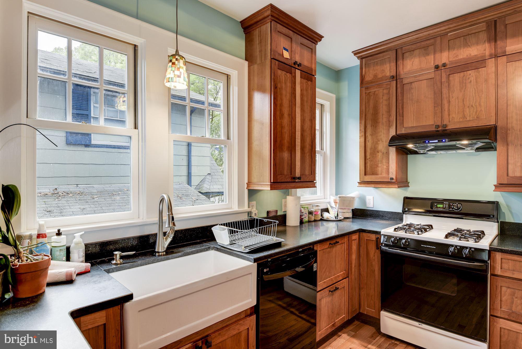 7413 Maple Avenue Takoma Park, MD 20912 - Photo 7 of 30 a kitchen with stainless steel appliances a stove sink and cabinets
