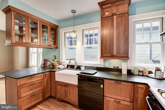 a kitchen with stainless steel appliances granite countertop a sink stove and cabinets