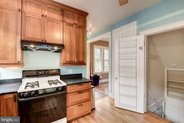 a kitchen with stainless steel appliances granite countertop a stove and a refrigerator