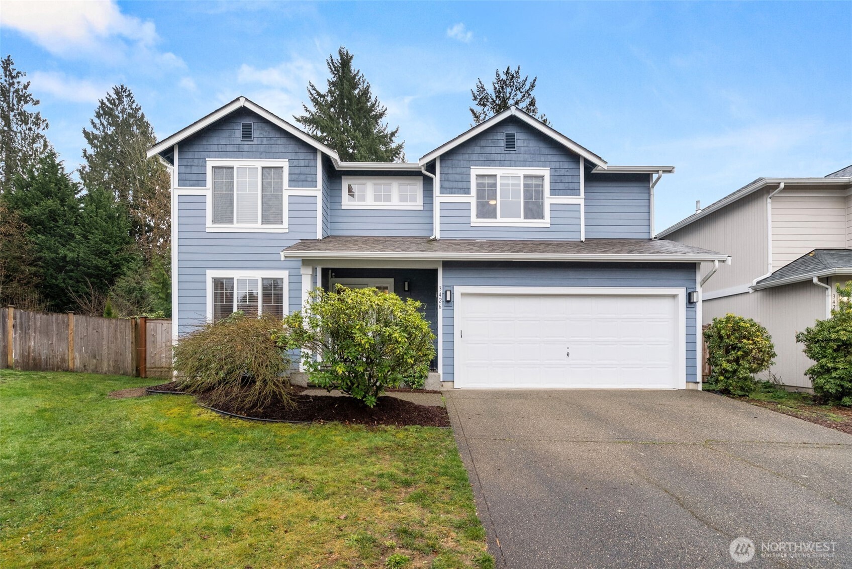 3426 Lady Fern Loop Northwest Olympia, WA 98502 - Photo 1 of 34 a front view of a house with a yard and garage