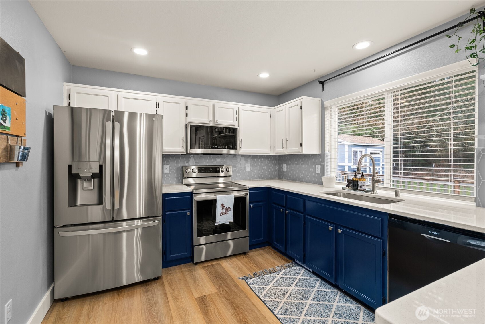 3426 Lady Fern Loop Northwest Olympia, WA 98502 - Photo 13 of 34 a kitchen with stainless steel appliances granite countertop a refrigerator stove a sink dishwasher and microwave
