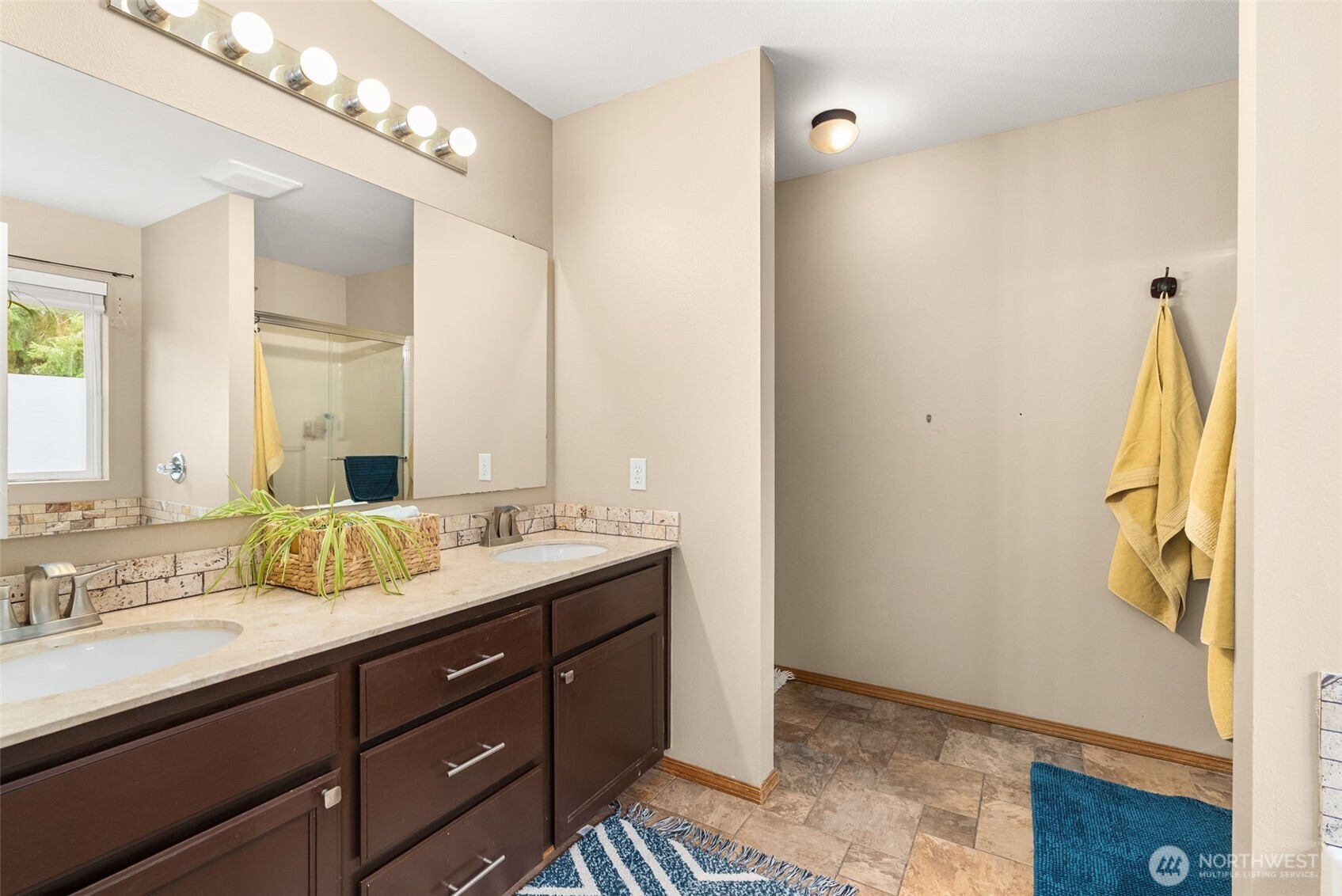 3426 Lady Fern Loop Northwest Olympia, WA 98502 - Photo 20 of 34 a bathroom with a double vanity sink and a mirror