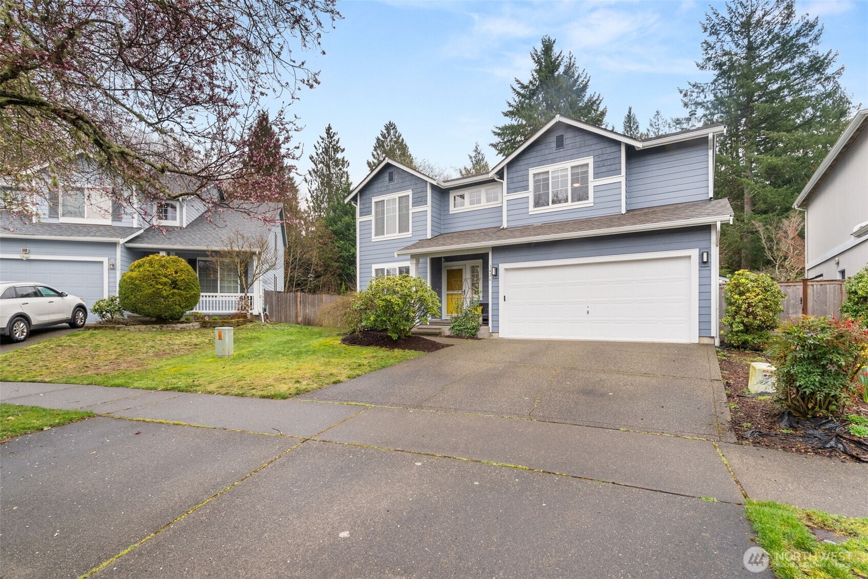 3426 Lady Fern Loop Northwest Olympia, WA 98502 - Photo 2 of 34 a view of the house with a yard and garage