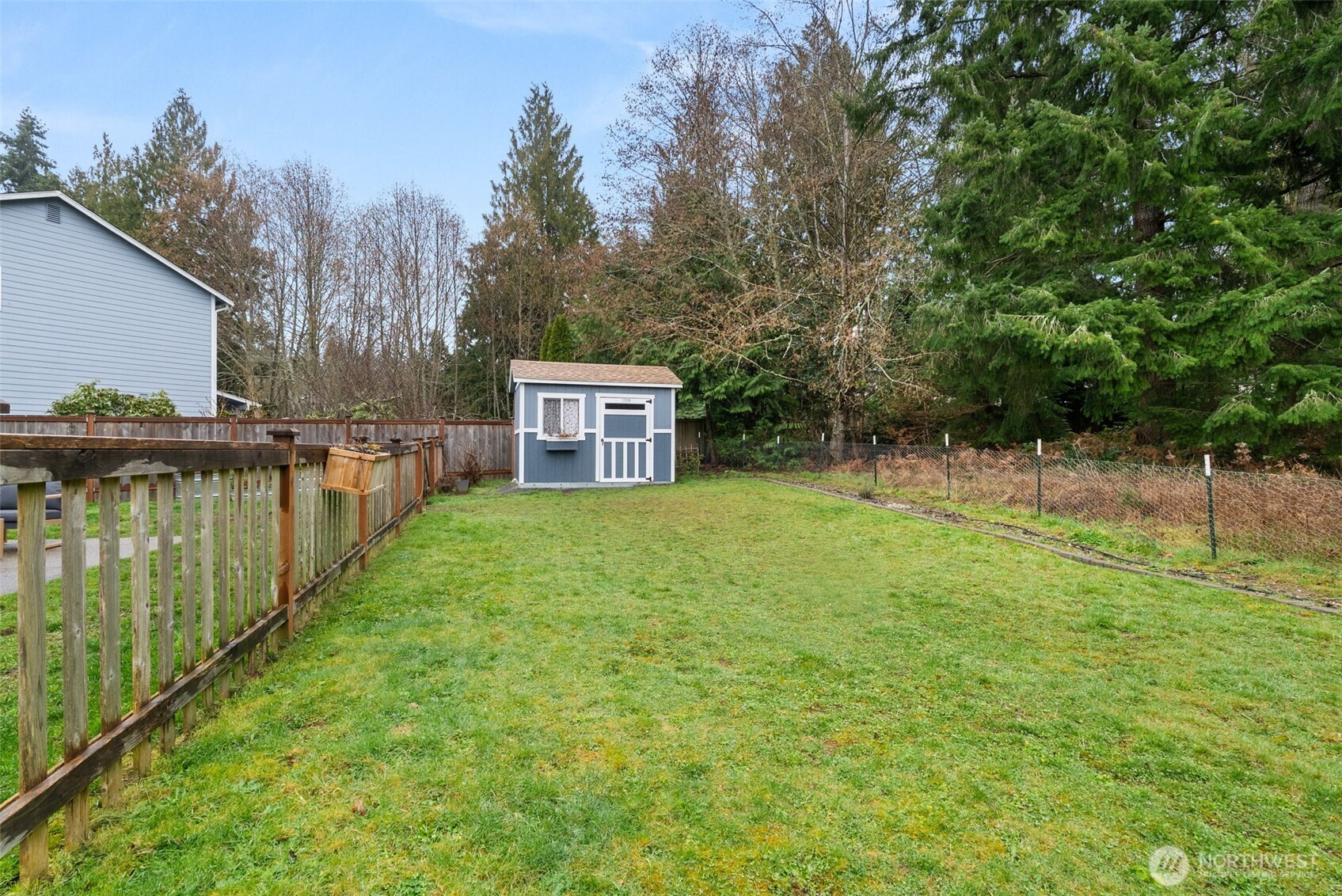 3426 Lady Fern Loop Northwest Olympia, WA 98502 - Photo 32 of 34 a backyard of a house with lots of green space