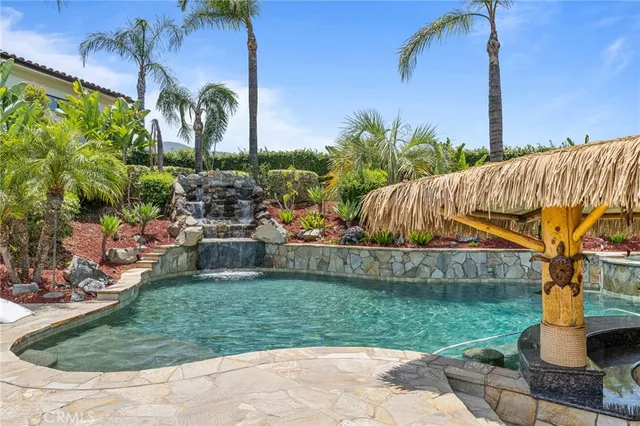 a view of an empty room with a fireplace and a chandelier