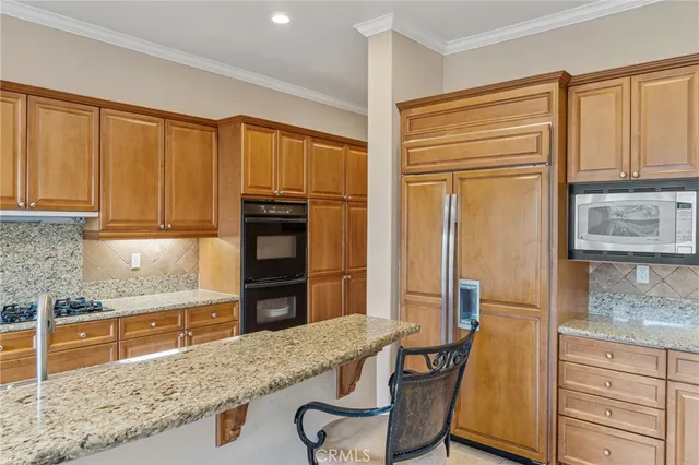 an empty room with windows cabinet and a living room