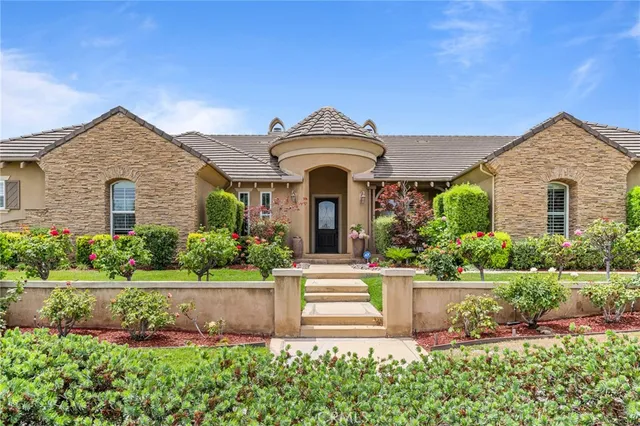a front view of a house with garden